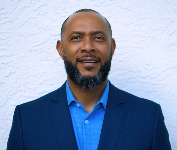 A man with a beard and blue shirt